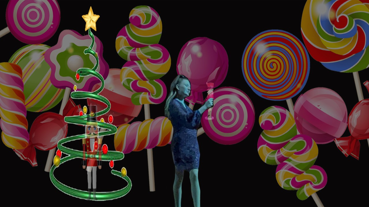 Spiral tree with a Nutcracker inside. A young girl holding a Nutcracker on a background filled with pictures of hard candy.